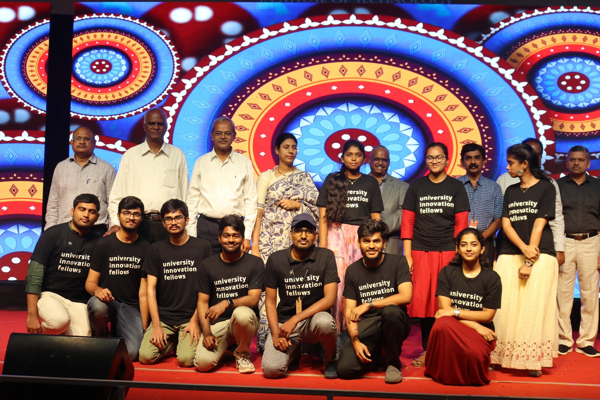 UIF fellows with dignitaries on a colorful cultural event stage