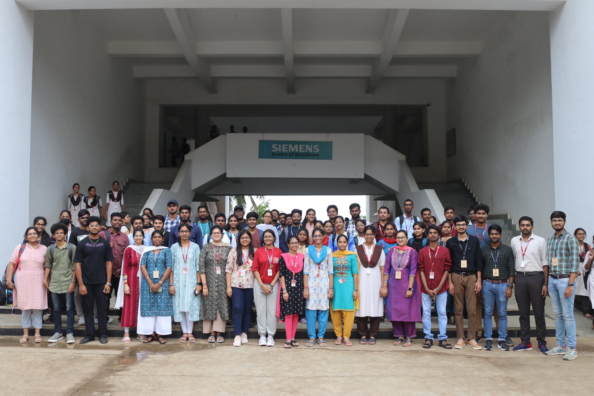 Large group photo outside the Siemens campus after a workshop