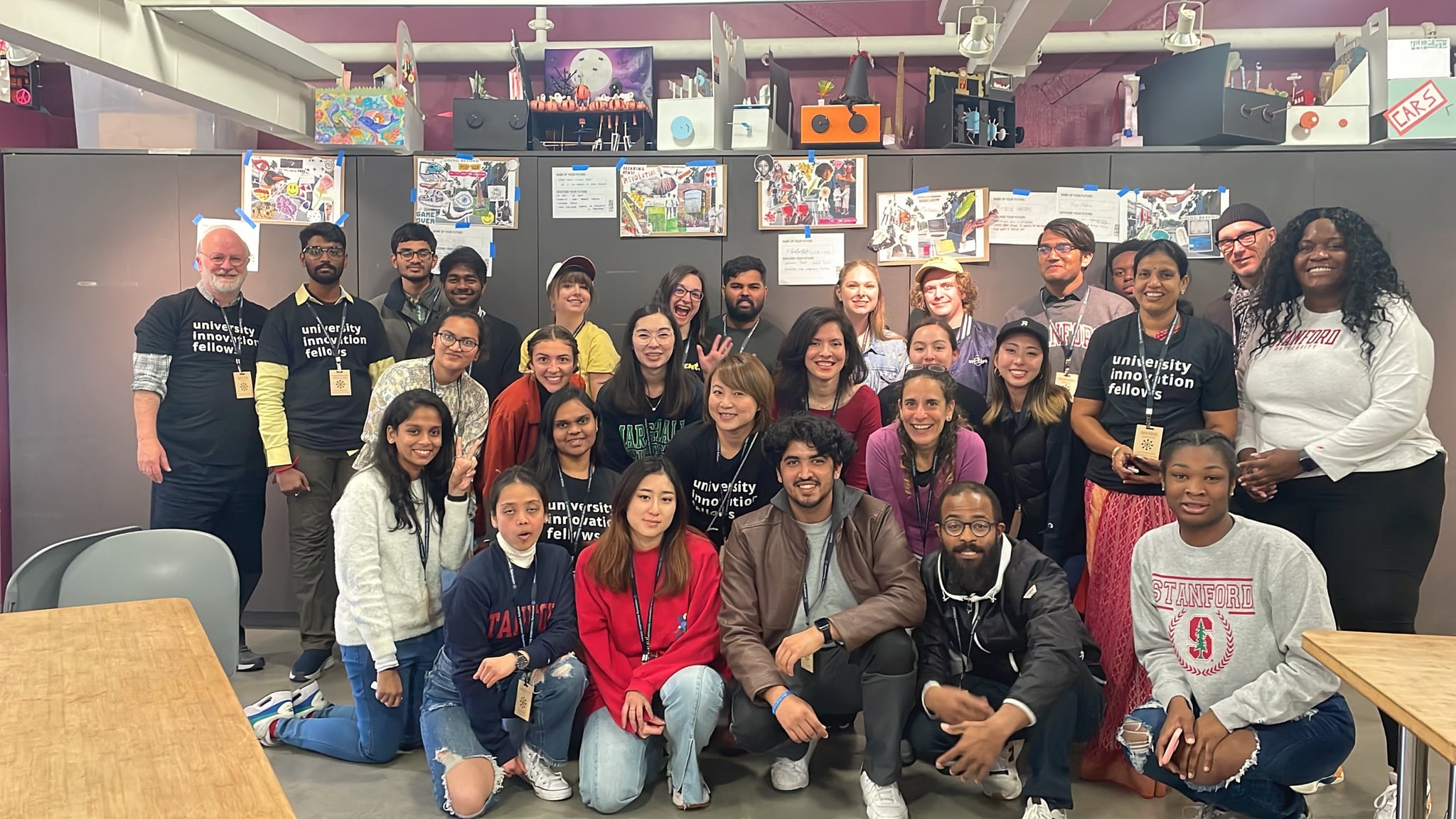 UIF fellows with Stanford students at the d.school, surrounded by colorful artwork and creative projects